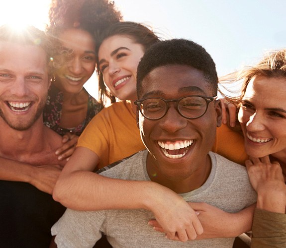 Young people smiling with clear aligners in Naperville