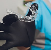 Dentist holding a clear aligner