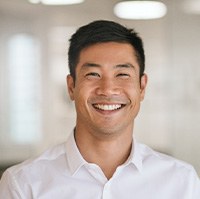 Man showing off a straighter smile at work