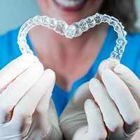 Woman holding clear aligners