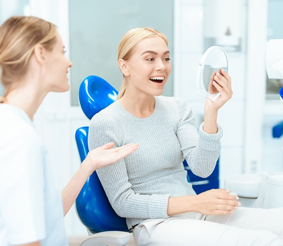 Dentist talking to female patient about her smile