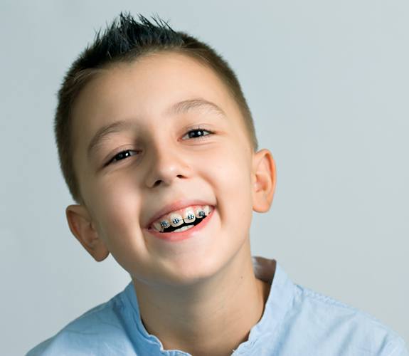 Young boy with blue shirt and braces in Naperville, IL