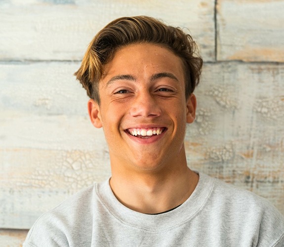 Male teenager showing off his healthy smile