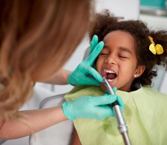 Little girl having her teeth cleaned