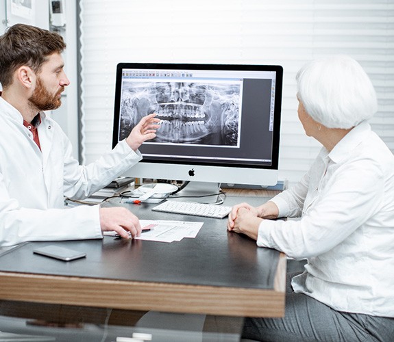 Dentist discussing X-rays with female patient