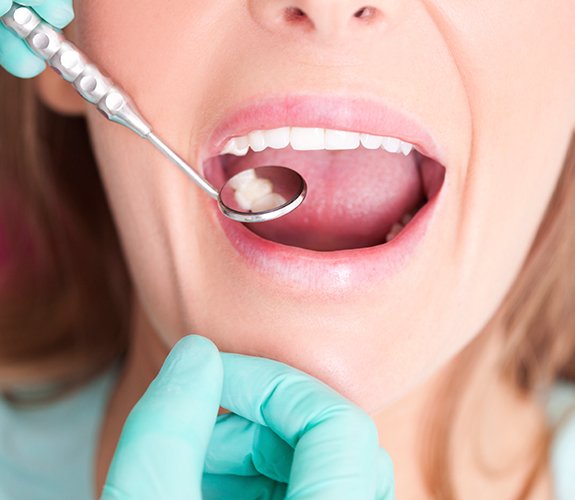 Dentist checking patient's metal free dental restoration