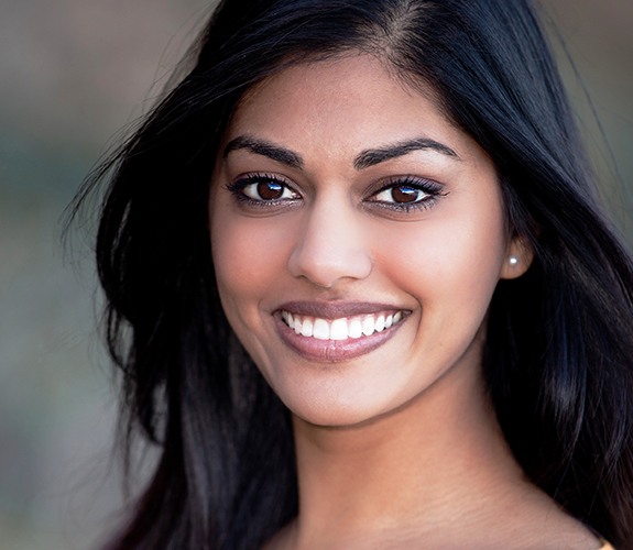 Woman with bright smile after teeth whitening