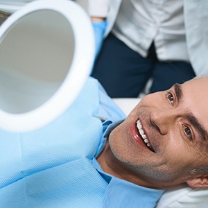 Man smiling after being fitted with new dentures