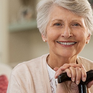 Older woman smiling while wearing dentures