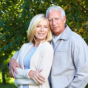 Couple smiling with dental implants in Naperville