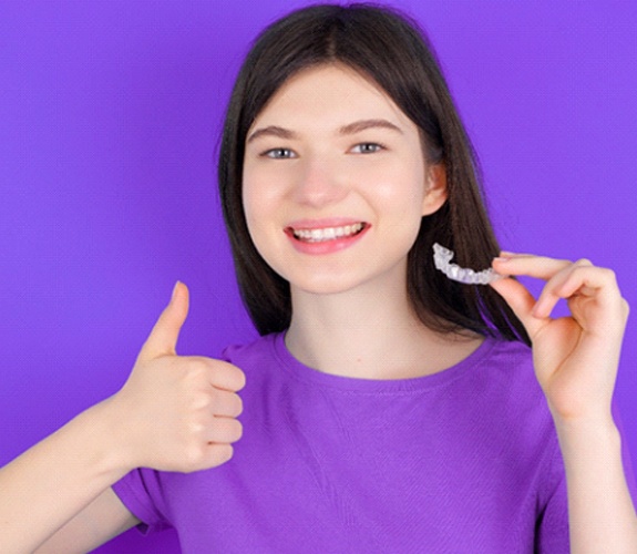Girl giving thumbs up for Invisalign for Teens in Naperville