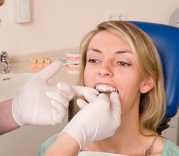 Dentist checking the fit of patient's Invisalign tray