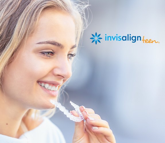 Woman placing an Invisalign tray