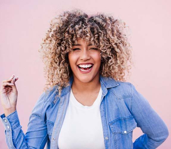 Smiling woman enjoying the benefits of metal-free restorations