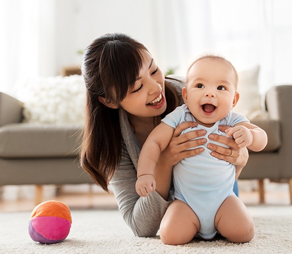 Baby laughing after frenectomy treatment for lip and tongue tie