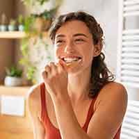 Young woman brushing her teeth