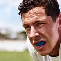 Male athlete wearing a blue mouthguard