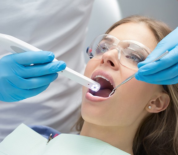 Dentist performing oral cancer screening