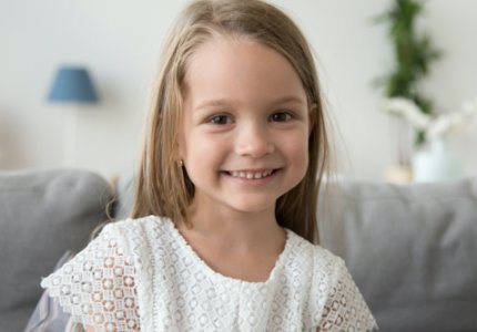 Young girl with healthy smile after children's dentistry