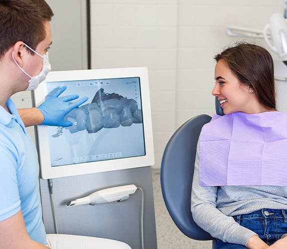 Dentist and patient looking at intraoral images