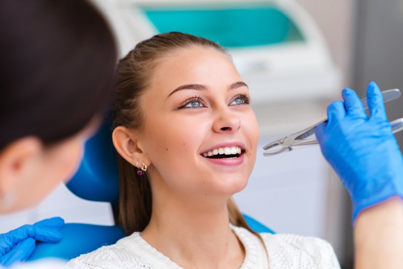 Dentist performing tooth extraction for gum disease