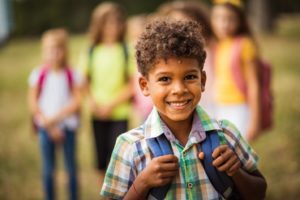 Child smiling on his way to school.