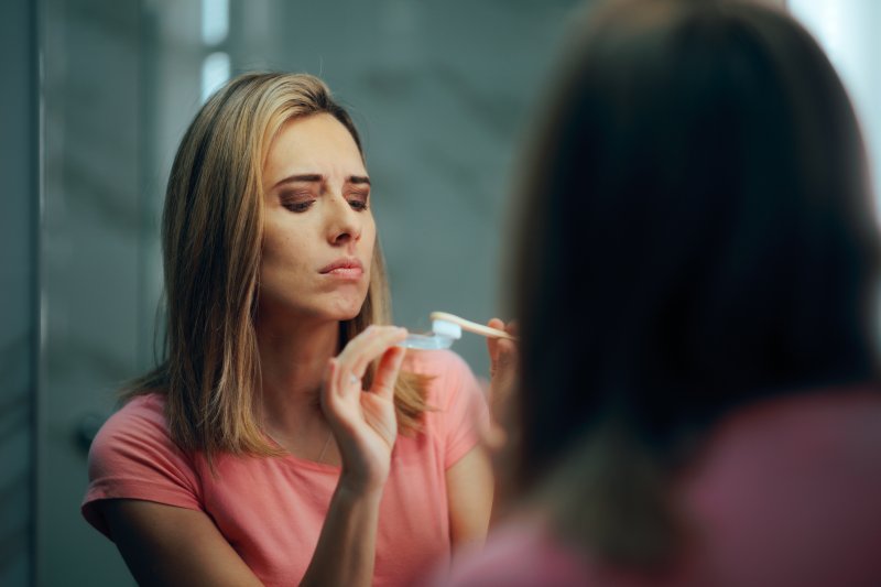woman cleaning her clear aligners